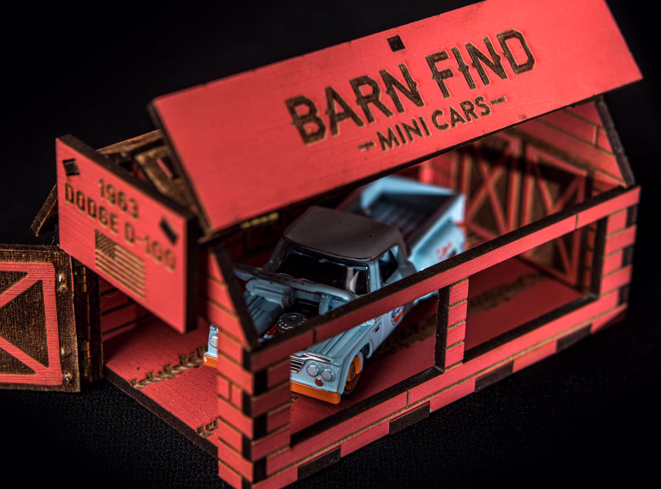 A close-up look of the USA set variation of Barn Find Mini Cars, showcasing the miniature Dodge pick-up truck and the custom packaging we designed, portraying the scene of an old American barn.
