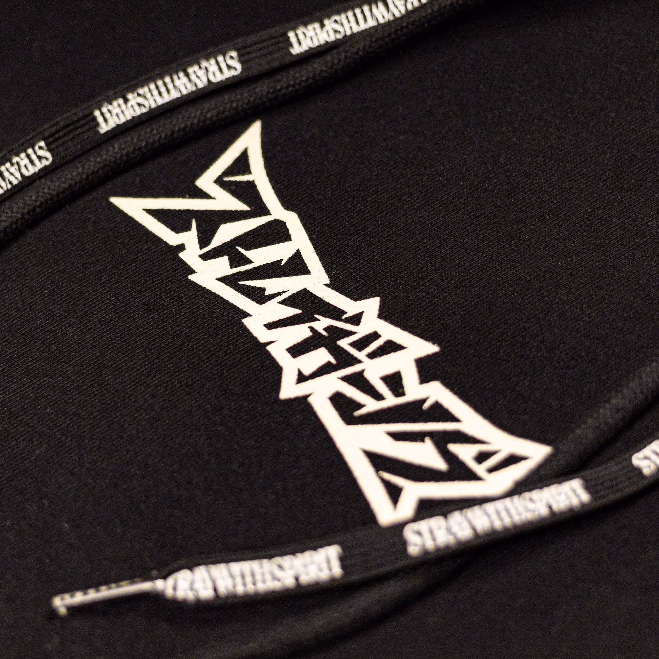 Close-up look at the front of Straygang's "Spirit Tag" black hoodie, showing the detailed screen-print and custom printed drawstrings.
